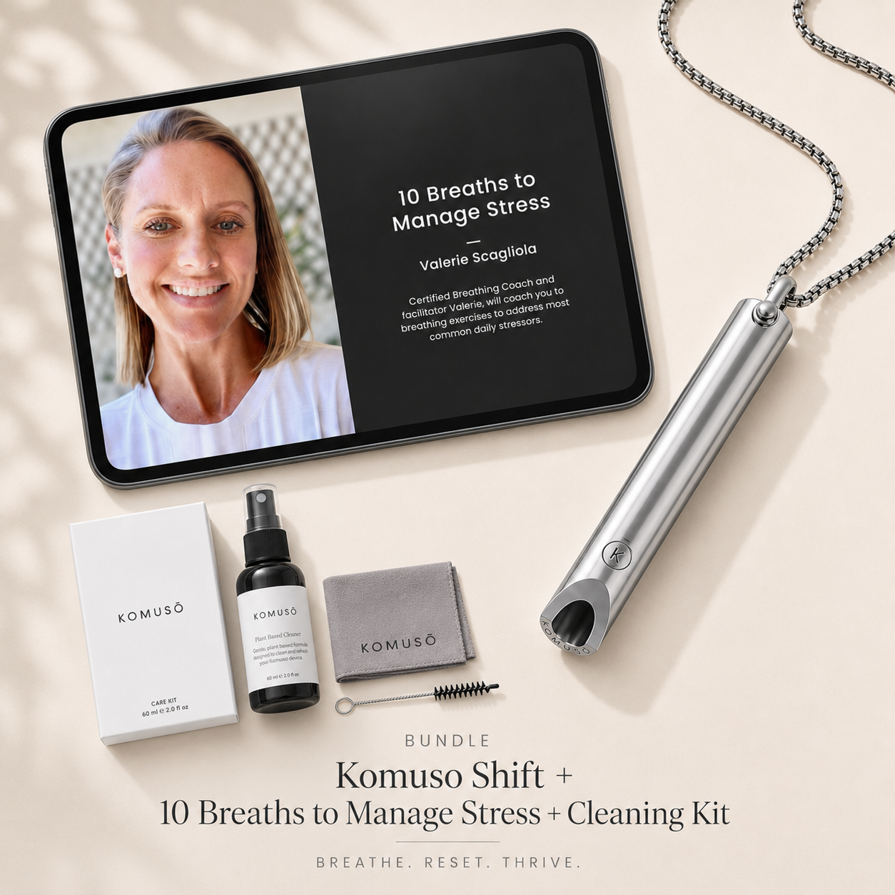 Komuso Shift + 10 Breaths to Manage Stress + Cleaning Kit on a light surface with a tablet displaying a video.